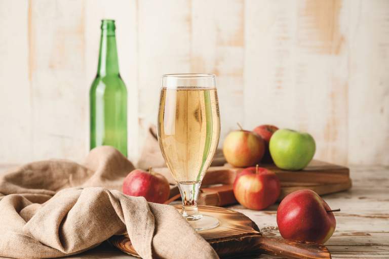 Glass of cider with apples