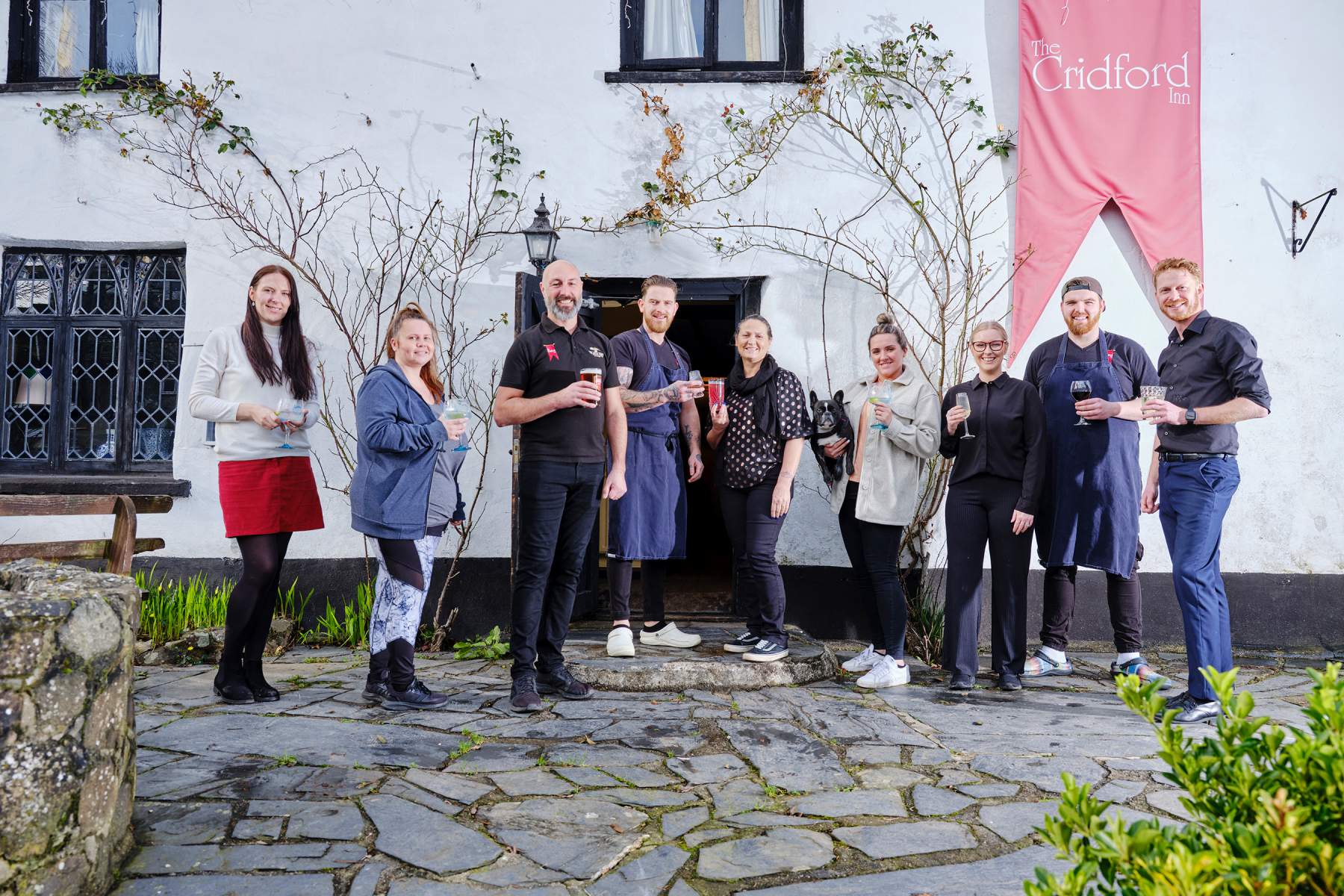 The Cridford Inn team standing outside the pub in Trusham