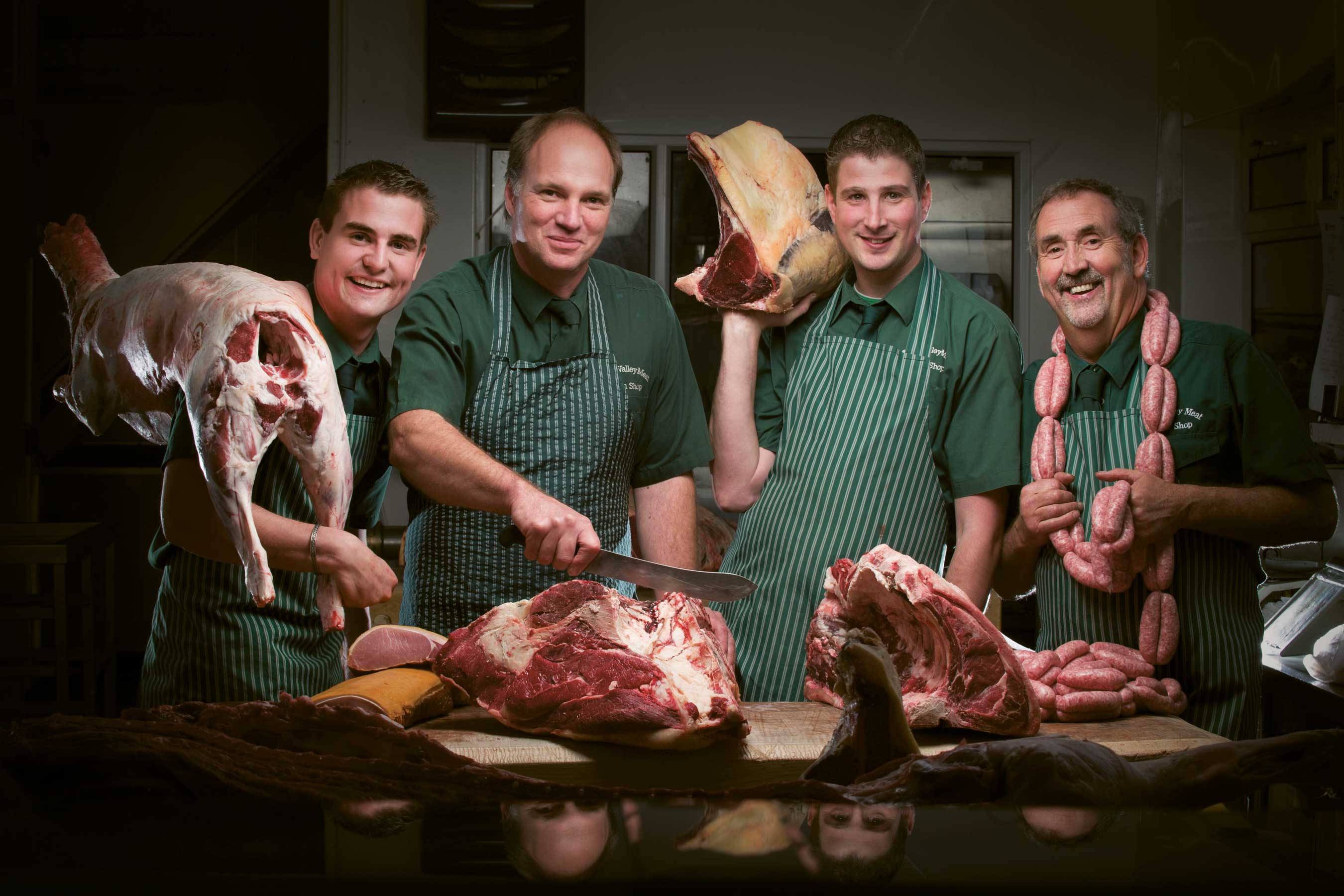 Aune Valley Meat butchers cutting and holding joints of meat