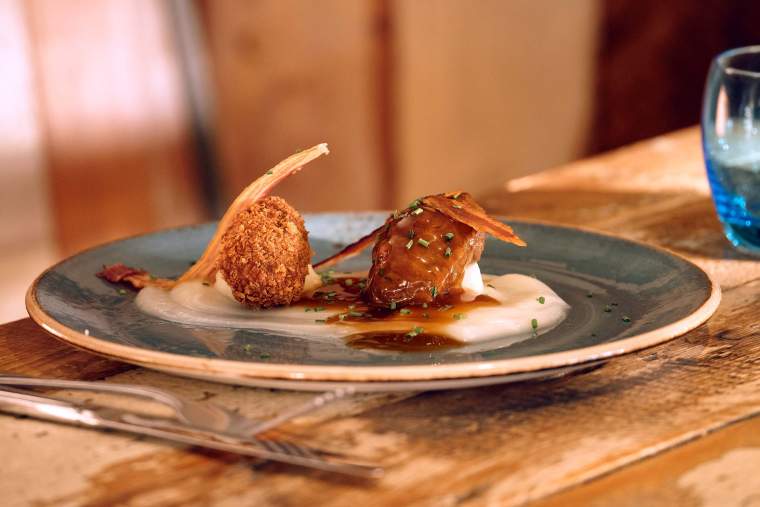 Braised pig cheeks with deep-fried black pudding, crispy pancetta and celeriac purée