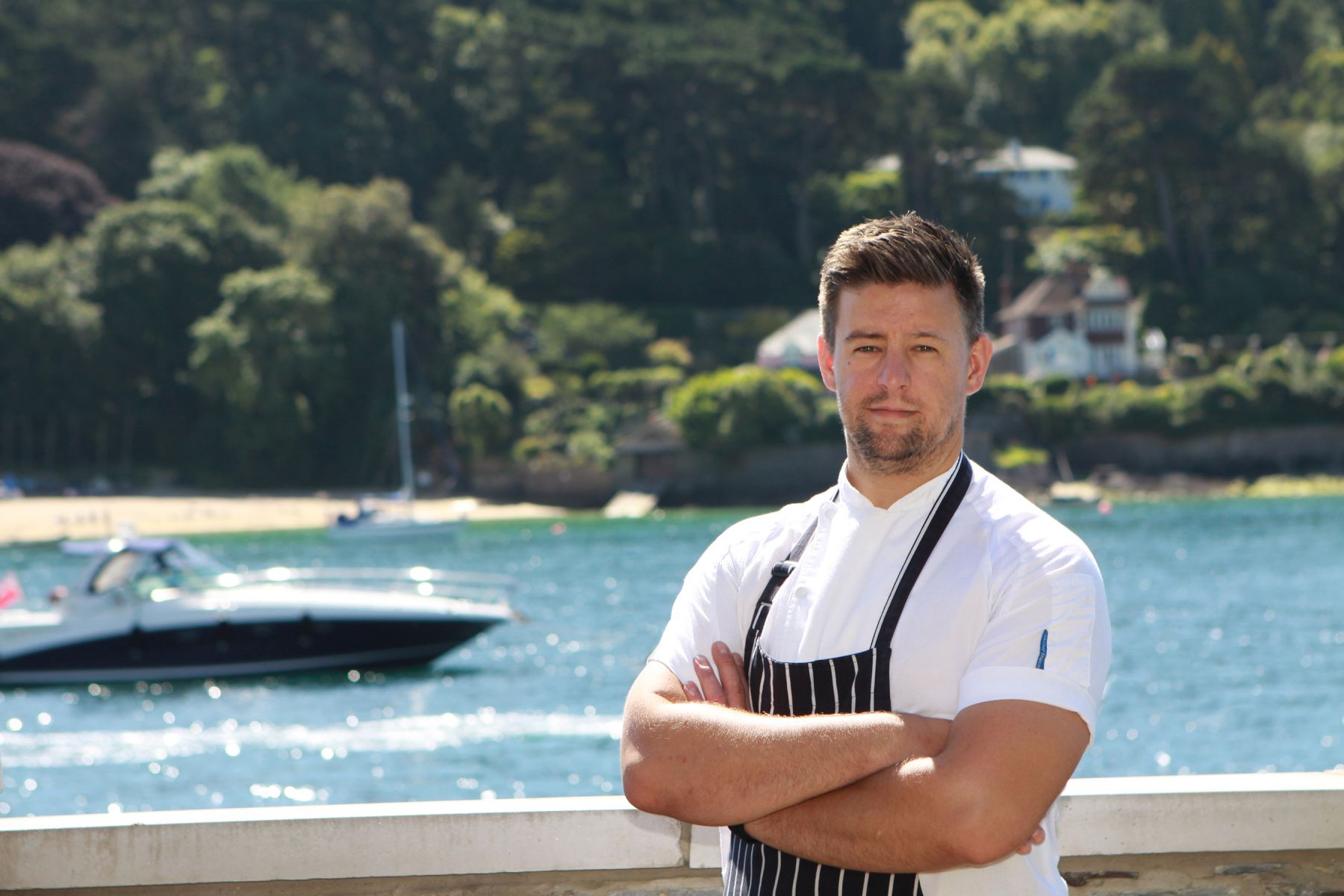 Jamie Guilford. Head Chef at Salcombe Harbour Hotel and Spa, Devon on the decking overlooking the water