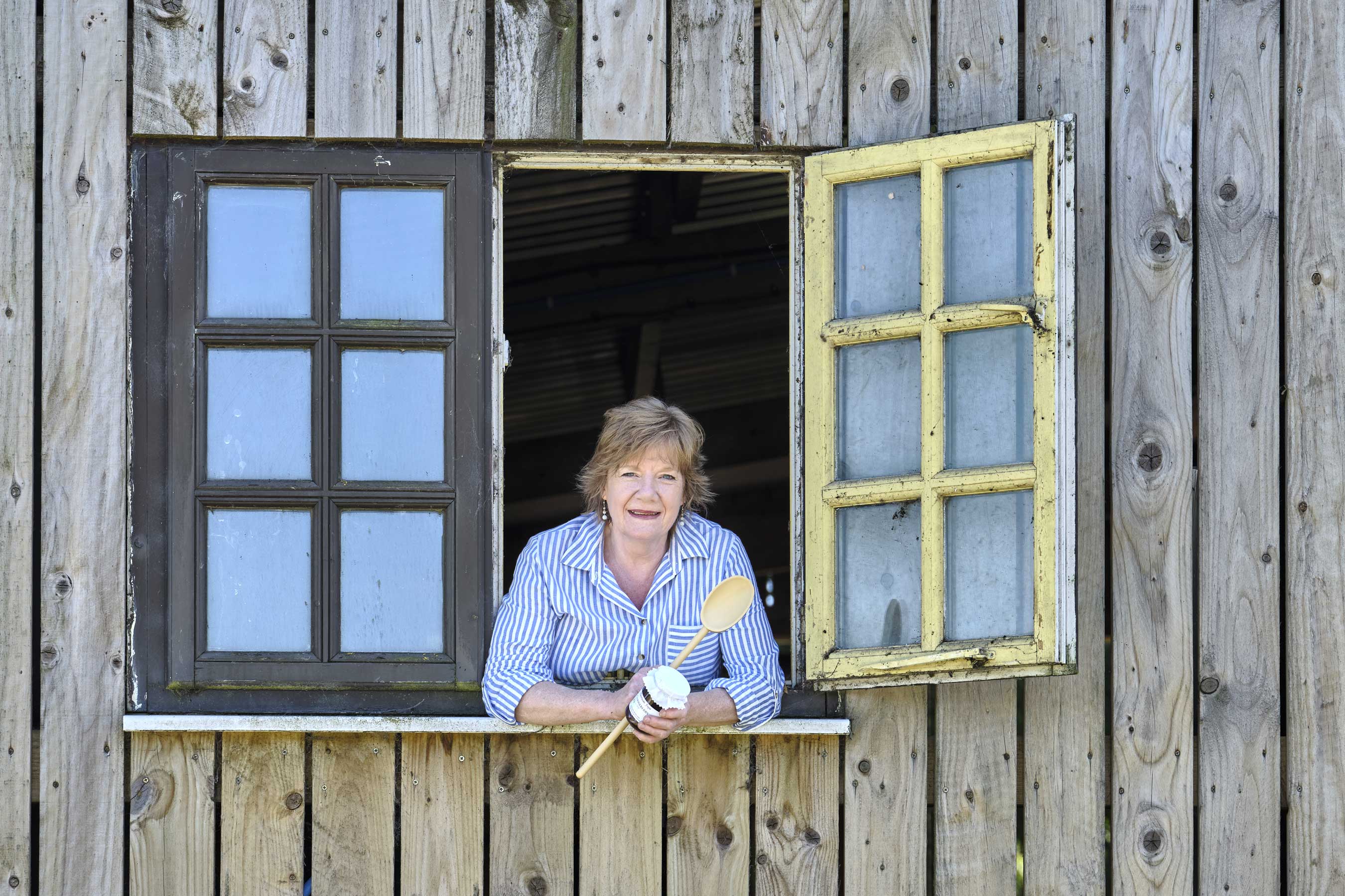 Ann Stallard, Waterhouse Fayre. Leaning out of her window, holding a wooden spoon