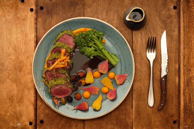 Pistachio-crusted venison in a black cherry jus