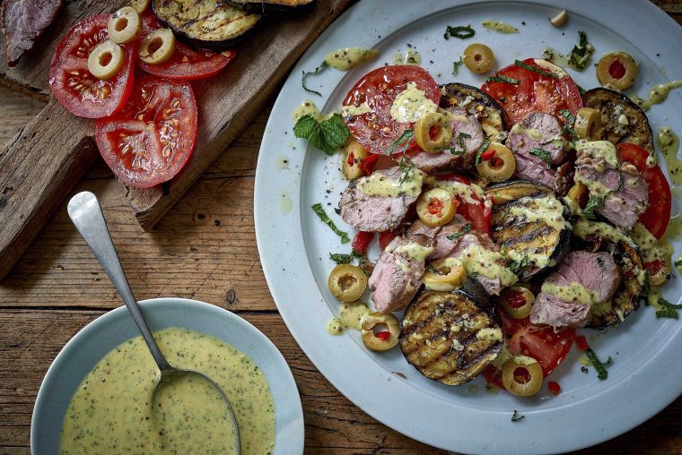 Roast lamb with charred aubergines, tomatoes and olives