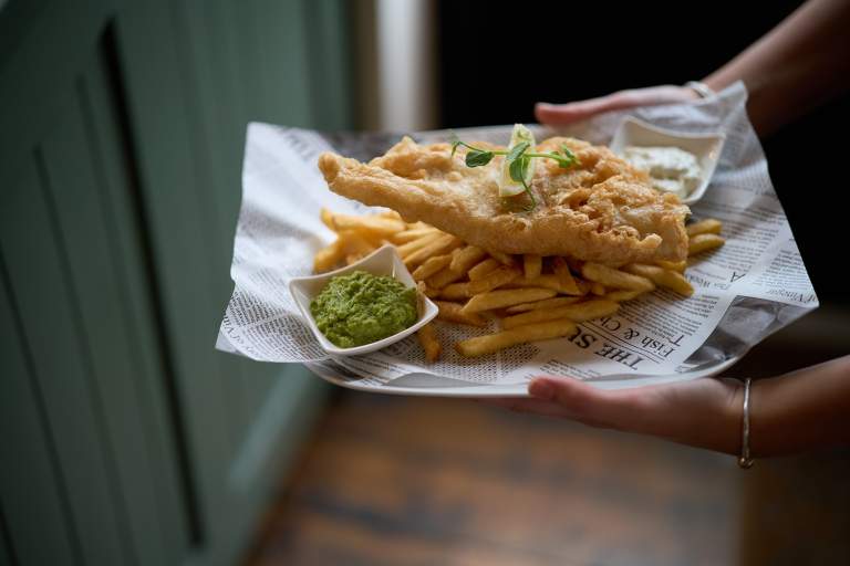 Fish and chips with mushy peas. The Beach Pub in Exmouth