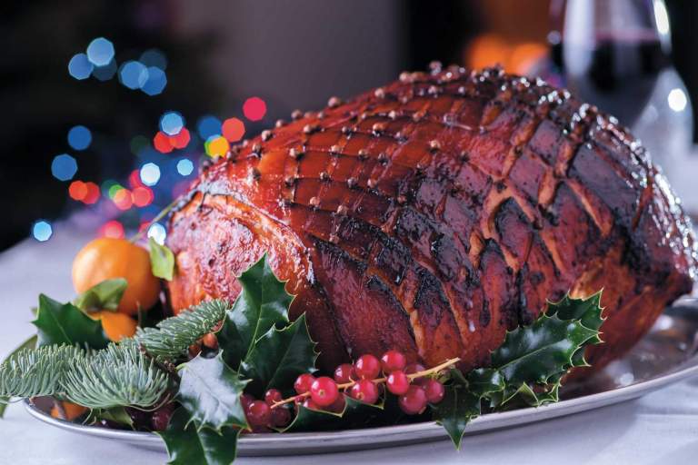 Roasted ham on the Christmas dinner table. Horn of Plenty, Devon