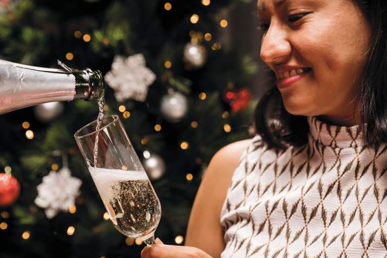 Happy woman holding champagne glass