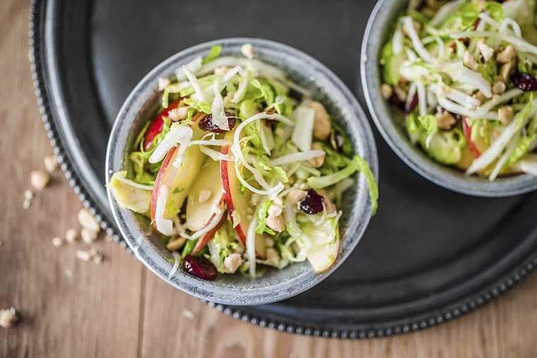 Raw Brussels sprout, cabbage & apple salad with chillies, cranberries and salted peanuts