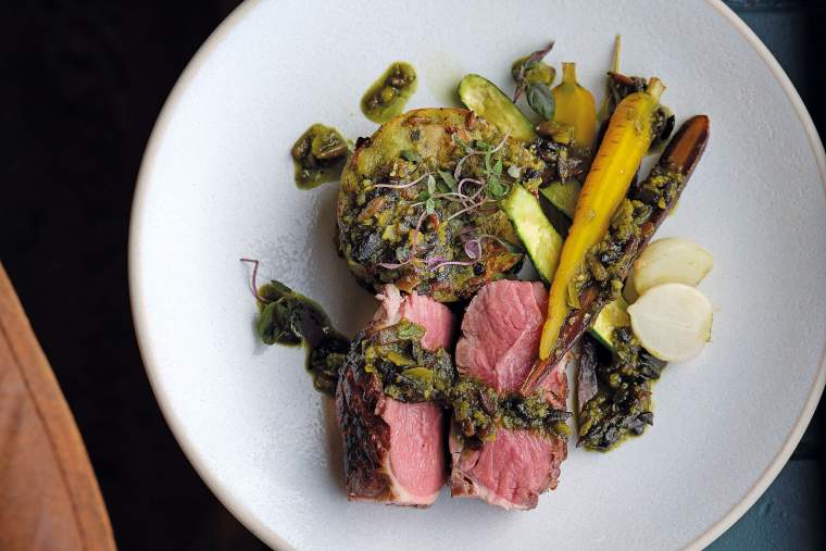 Roast lamb rump with baby vegetables and pesto-crushed potato cake