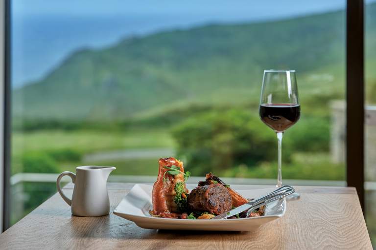 A dish served at Soar Mill Cove. View through window to the view beyond